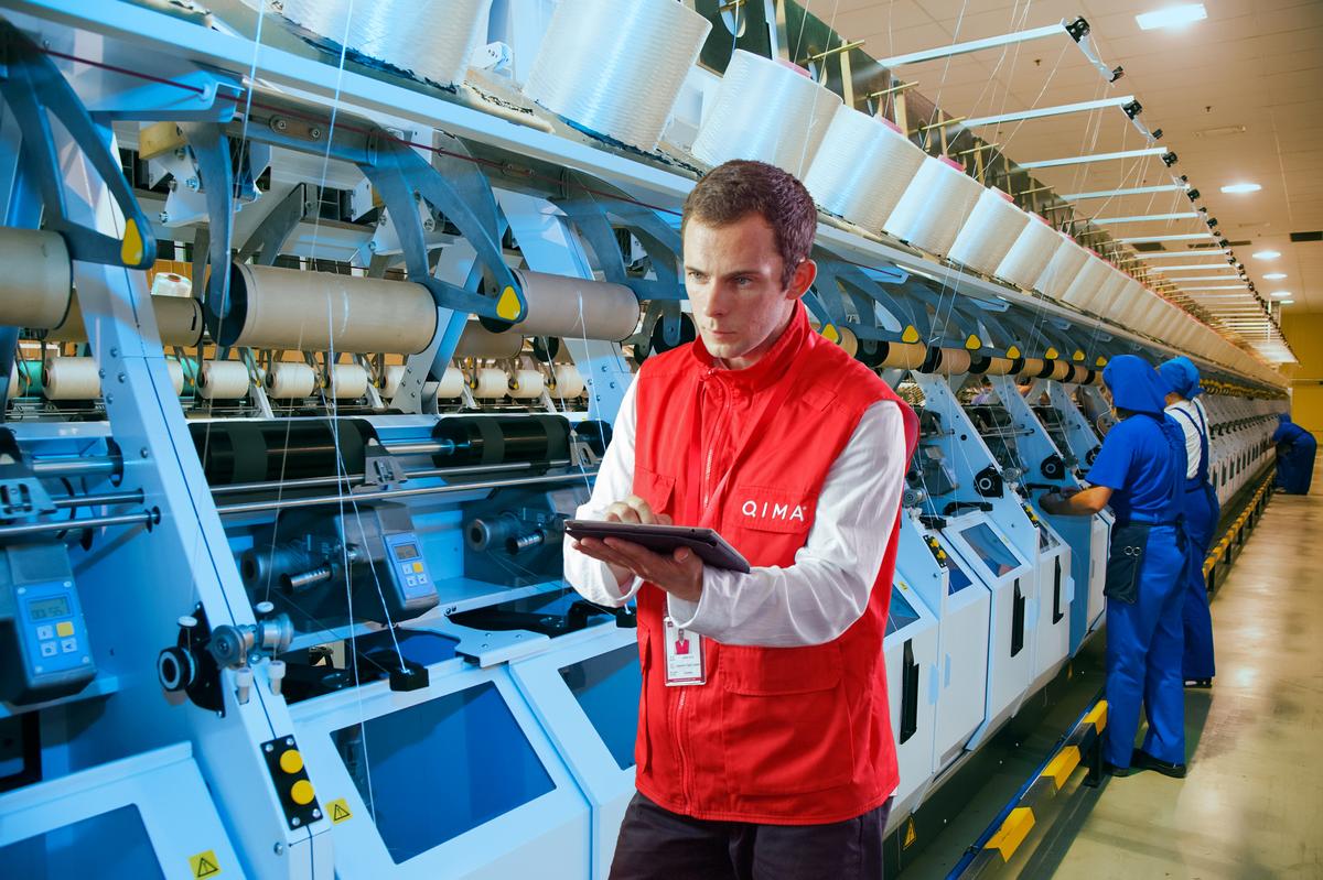 QIMA inspector performing initial production check inside factory